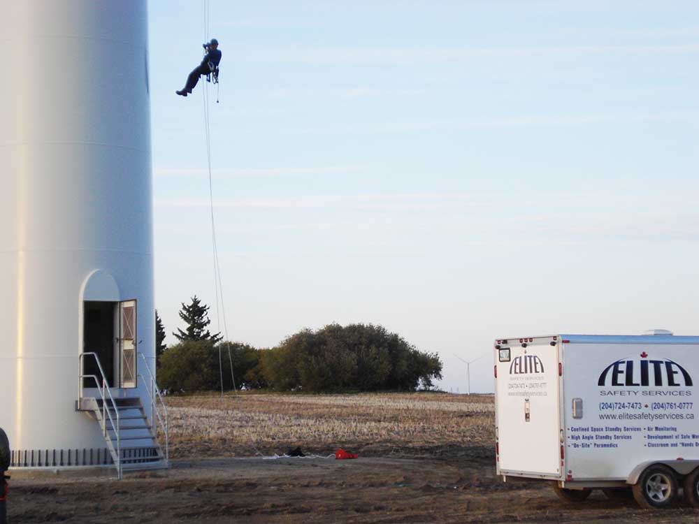 Rope Access - Worker using ropes to scale the outside of a wind turbine tower